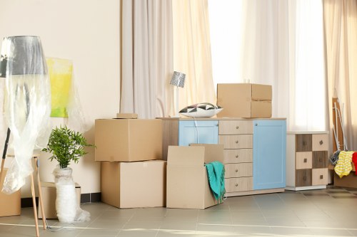 Local moving truck loading furniture and boxes in Epsom