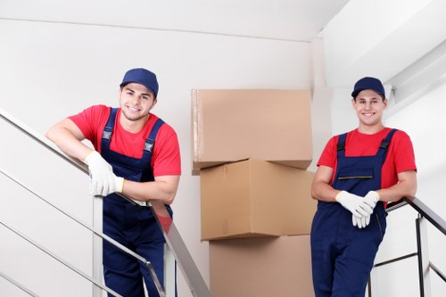 Moving team handling boxes safely with protective equipment